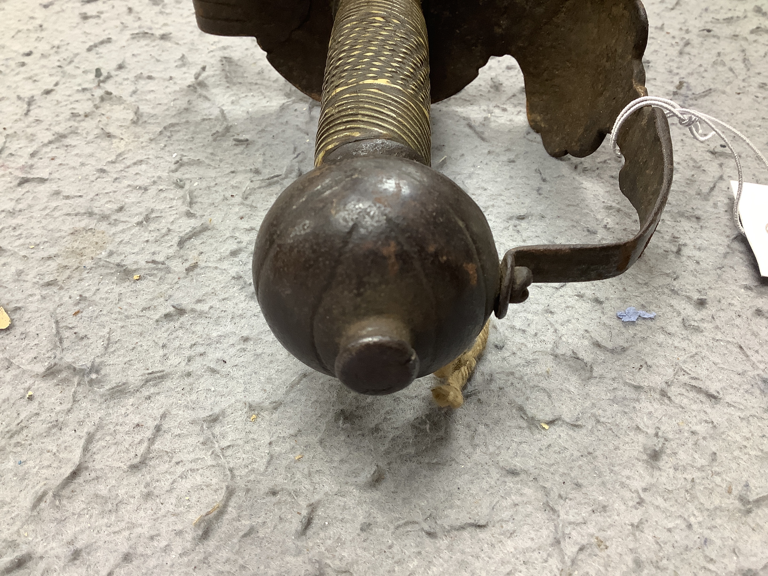 An English hangar, mid 17th century, curved fullered blade engraved with spurious date 1535 and running wolf mark, iron guard slightly reduced and swollen pommel, spirally carved and chequered bone grip, blade 67.5cm